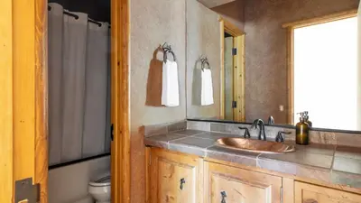 a bathroom with a sink and a mirror at Bernard by AvantStay Luxurious Cabin in Big Bear w Hot Tub Pool Table in Big Bear Lake