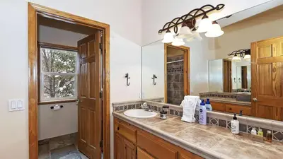a bathroom with a sink and a mirror at Zen Den by AvantStay Entertainers Home in Ideal Big Bear Location w Hot Tub in Big Bear Lake