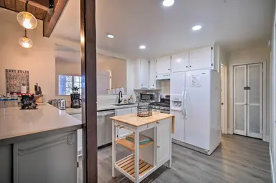 a kitchen with white cabinets and a white refrigerator at Relaxing Lake Arrowhead Home about 1 Mi to Lake! in Lake Arrowhead