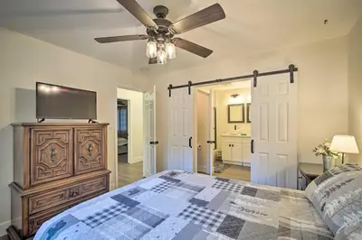a bedroom with a bed and a ceiling fan at Relaxing Lake Arrowhead Home about 1 Mi to Lake! in Lake Arrowhead