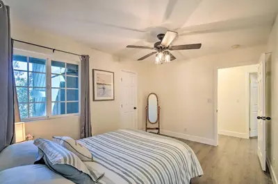 a bedroom with a bed and a ceiling fan at Relaxing Lake Arrowhead Home about 1 Mi to Lake! in Lake Arrowhead