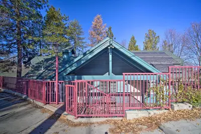 a house with a red gate in front of it at Relaxing Lake Arrowhead Home about 1 Mi to Lake! in Lake Arrowhead