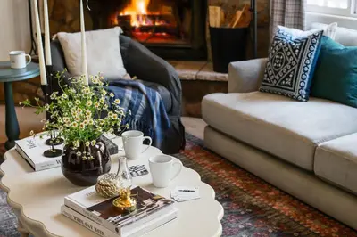 a living room with a coffee table and a couch at Hartwood by AvantStay Cozy Big Bear Abode w Spacious Deck Stone Fireplace in Big Bear Lake