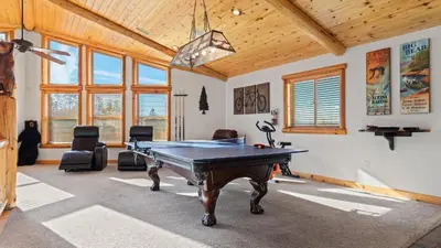 a room with a ping pong table in it at Starlight Retreat by AvantStay Gorgeous Log Style Home w Incredible Views in Big Bear Lake