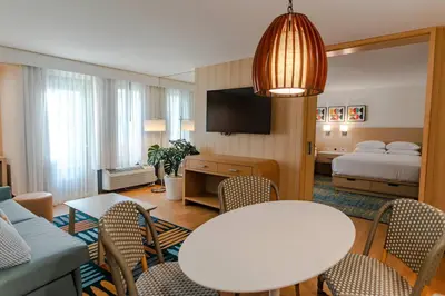a hotel room with a table and a bed at Howard Johnson by Wyndham Anaheim Hotel and Water Playground in Anaheim