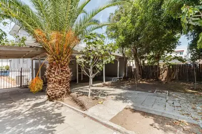 a palm tree in front of a house at 5 Bedroom Koreatown Charmer near DTLA in Los Angeles
