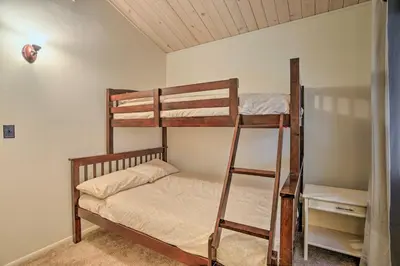 a bedroom with two bunk beds with a ladder at Lake Arrowhead Cabin with Mid-Century Charm! in Lake Arrowhead