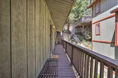 a hallway of a building with a wooden walkway at Lake Arrowhead Cabin with Mid-Century Charm! in Lake Arrowhead