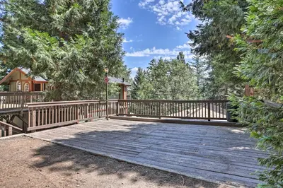 a wooden bridge in a yard with a house at Lake Arrowhead Cabin with Mid-Century Charm! in Lake Arrowhead