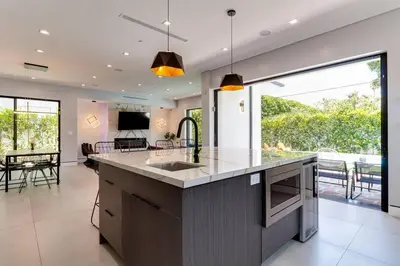a kitchen with a large island with a sink at Posh Luxury Modern Home with Pool Spa and Rooftop Deck in Encino