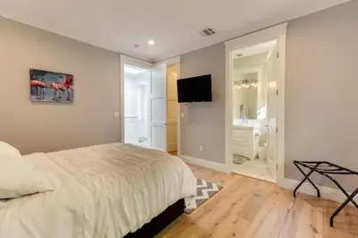 a bedroom with a bed and a flat screen tv at Beautiful 2 Story Right by the Water, Ocean View in Long Beach