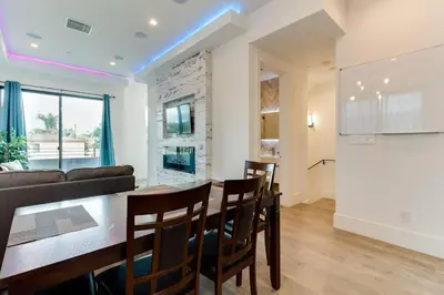 a kitchen and living room with a table and chairs at Luxury Modern 4 bedroom 3 Bath Home With Rooftop Deck #3 in Los Angeles