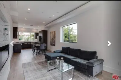 a living room with a couch and a table at 2 Luxury Modern 8 Bedroom Home with Rooftop Decks in Los Angeles