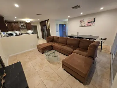 a living room with a couch and a table at 4 Bedroom West Hills Charmer with Pool and Jacuzzi in Los Angeles