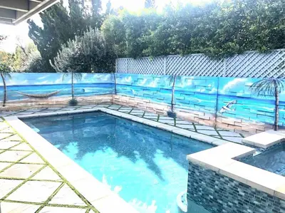 a swimming pool with a blue fence around it at Luxury house pool & Spa 10 mins from Hollywood & Universal Studios in Los Angeles