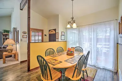 a dining room with a table and chairs at 3 Mi to Skiing Big Bear Cabin with Deck in Big Bear City