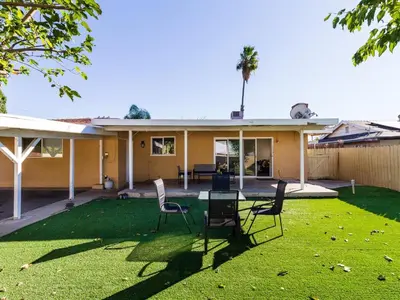 a house with chairs in the yard at 5 Bedroom Charmer in Granada Hills in Granada Hills
