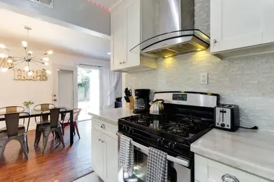 a kitchen with a stove and a dining room at Valley Modern Glam Charmer in Reseda