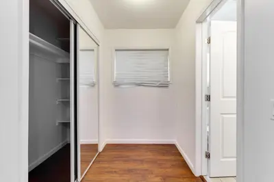 a hallway with a mirror and a closet at Valley Modern Glam Charmer in Reseda