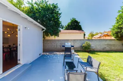 a patio with chairs and a table in a yard at Valley Modern Glam Charmer in Reseda
