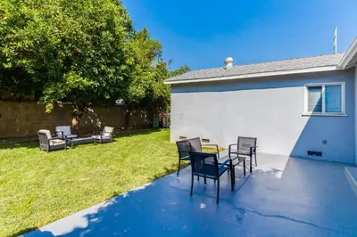 a patio with chairs and a table in a yard at Valley Modern Glam Charmer in Reseda