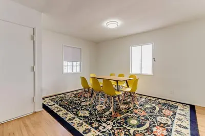 a dining room with a table and yellow chairs at New 4 bedroom Modern Villa in Mar Vista in Los Angeles