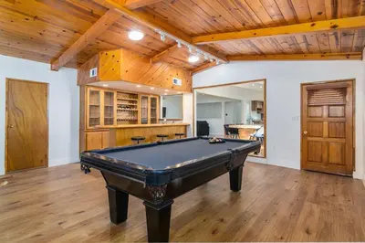 a pool table in a room with wooden ceilings at 4 Bedroom house large pool & spa in prime location in Los Angeles