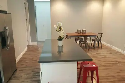 a kitchen and dining room with a table and chairs at Lake Balboa Modern 4 Bedroom 3 Bath Glam Charmer in Raymer