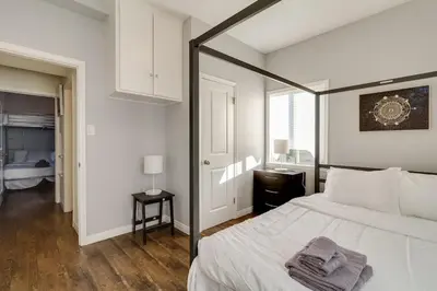 a bedroom with a large bed with a black frame at Cozy 3 bedroom San Fernando Valley in San Fernando