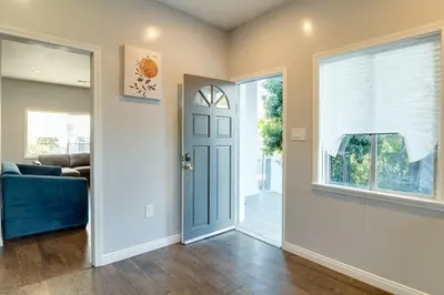 a living room with a blue door and a window at Cozy 3 bedroom San Fernando Valley in San Fernando