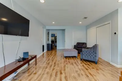 a living room with a couch and a tv at 4 bedroom house with a pool in Reseda