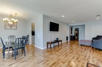 a living room with a table and chairs and a television at 4 bedroom house with a pool in Reseda