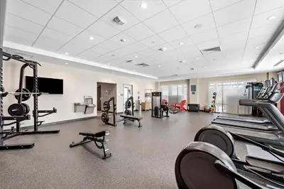 a gym with several treadmills and machines in a room at Home2 Suites By Hilton San Bernardino in San Bernardino