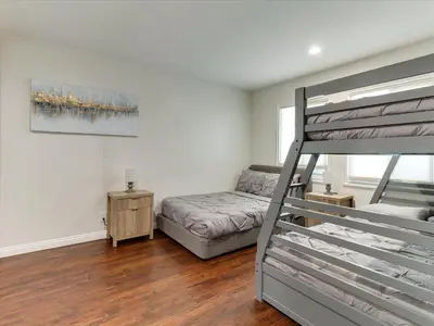 a bedroom with a bunk bed and a couch at Woodland Hills Zen Modern in Woodland Hills