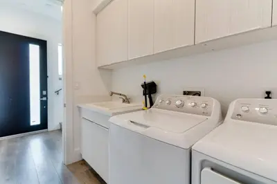 a white laundry room with a washer and dryer at Luxury Modern 4 Bedroom 3 Bathroom Home with Rooftop Deck #1 in Los Angeles
