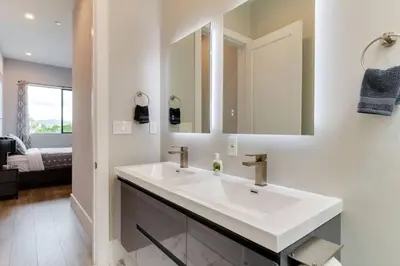 a white bathroom with a sink and a mirror at Luxury Modern 4 Bedroom 3 Bathroom Home with Rooftop Deck #1 in Los Angeles