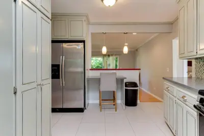a kitchen with a refrigerator and a table in it at Woodland Hills Charmer in Los Angeles
