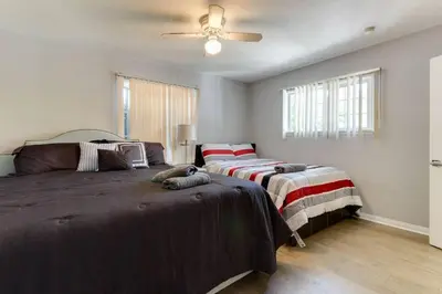 a bedroom with two beds and a ceiling fan at Woodland Hills Charmer in Los Angeles