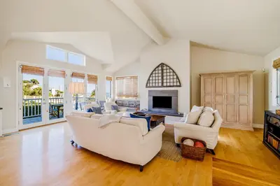 a living room with two white couches and a fireplace at Golden Getaway in Summerland