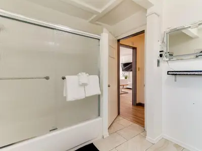 a bathroom with a glass shower with a towel at 3 bedroom Mid-Wilshire Charmer near Downtown in Los Angeles