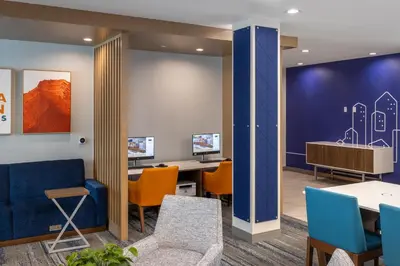 an office with blue and orange chairs and desks at Holiday Inn Express & Suites Hawaiian Gardens by IHG in Hawaiian Gardens