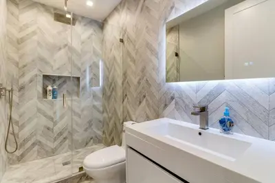 a bathroom with a sink and a toilet and a mirror at 3 Luxury Modern Homes 12 bedrooms & Rooftop Decks in Los Angeles