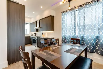 a kitchen and dining room with a table and chairs at 3 Luxury Modern Homes 12 bedrooms & Rooftop Decks in Los Angeles