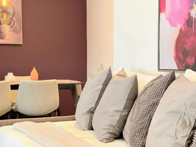 a bedroom with a bed with pillows and a table at Hollywood Purple Habitat in Los Angeles