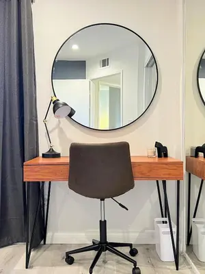 a desk with a circular mirror and a chair at Hollywood Black Habitat in Los Angeles