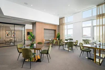 a dining room with tables and chairs and windows at Level Los Angeles - Downtown Flower in Los Angeles