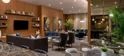 a hotel lobby with tables and chairs at Level Los Angeles - Downtown Flower in Los Angeles