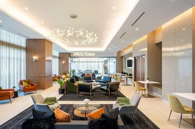 a lobby of a hotel with couches and chairs at Level Los Angeles - Downtown Flower in Los Angeles