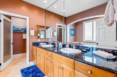 a bathroom with two sinks and a large mirror at Rivo of Dreams in Long Beach