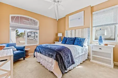 a bedroom with a bed and a blue chair at Rivo of Dreams in Long Beach